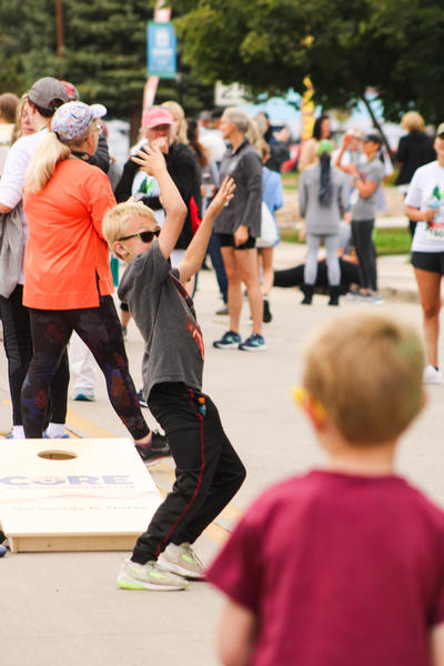Boy playing cornhole